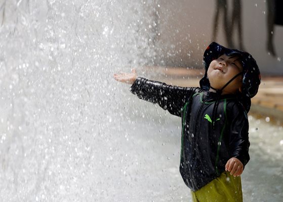 2-годишно дете си играе с водата от фонтан, за да се охлади от адските жеги.
СНИМКИ: РОЙТЕРС