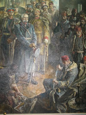Платното показва как Осман паша предава сабята си на победителите, поема я ген. Ганецки.