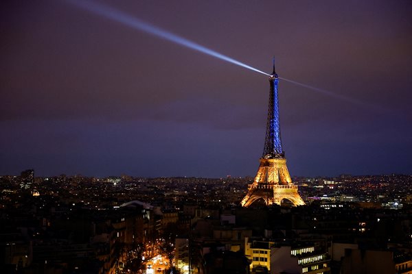 The Eiffel Tower is lit up in the national blue-and-yellow colours of Ukraine, to mark the first anniversary of Russia's invasion of Ukraine, in Paris, France, February 23, 2023. REUTERS/Sarah Meyssonnier