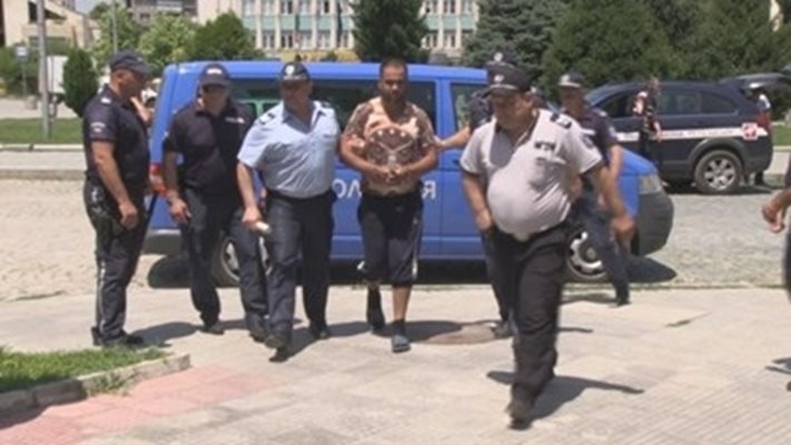Полицаи водят Валенти Маринов в съда през 2017 г. СНИМКА: Росен Моллов/архив