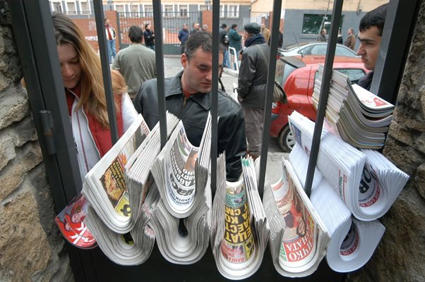 Българска преса в Мадрид, Испания. “Щандът” се намира на оградата на метална ограда до автогарата, а вестниците се доставят от българските шофьори на автобуси. 

СНИМКА: “24 ЧАСА”