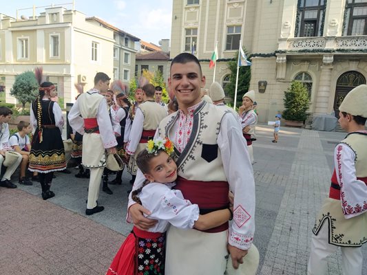 Танцьори от ансамбъл "Дилянка" се гушка в по-големия батко.