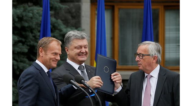 Президентът на Украйна Петро Порошенко разговаря с Доналд Туск (вляво) - председател на Еввропейския съвет, и с шефа на Европейската комисия Жан-Клод Юнкер.  СНИМКА:  РОЙТЕРС