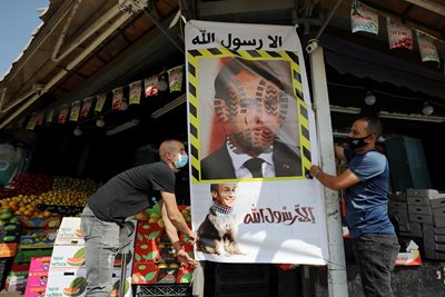 Vendors in the Arab quarter of Jerusalem put up a poster against Macron.  PHOTO: Reuters