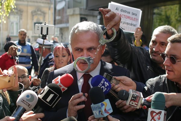 Румънец размахва белезници пред Ливиу Драгня на протест в Букурещ през 2017 г.  СНИМКА: РОЙТЕРС