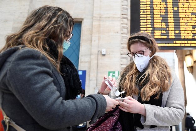 Хора дезинфекцират ръцете си на жп гара в Милано
