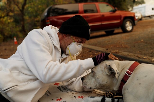 Жител на Калифорния се радва на оцелялото си куче.  СНИМКИ: РОЙТЕРС